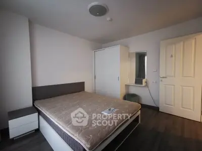 Spacious bedroom with modern furnishings and ample storage in a stylish apartment.