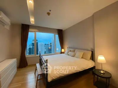 Spacious bedroom with city view in modern high-rise apartment