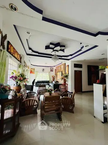 Elegant living room with stylish ceiling design and wooden furniture, perfect for family gatherings.
