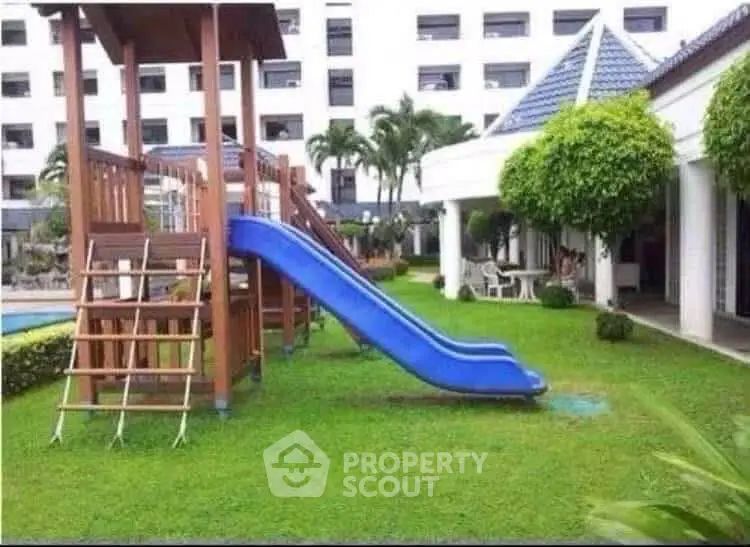 Charming residential complex with lush garden and children's play area, perfect for family living.