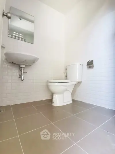 Modern minimalist bathroom with white tiles and sleek fixtures