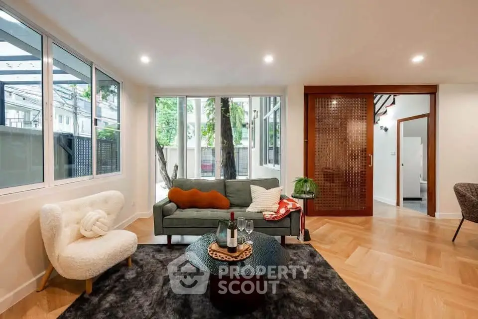 Stylish living room with modern furniture and large windows offering natural light.