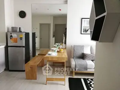 Modern living room with sleek furniture and compact kitchen area, perfect for urban living.