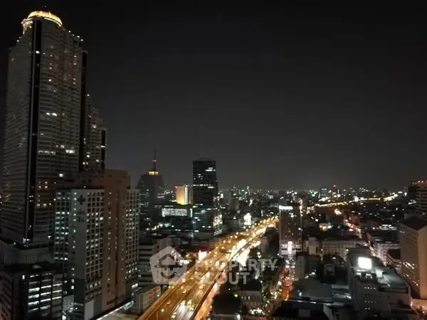 Stunning cityscape view from high-rise building at night with illuminated skyline.