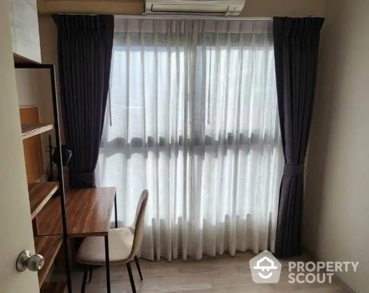 Cozy study room with natural light and elegant curtains