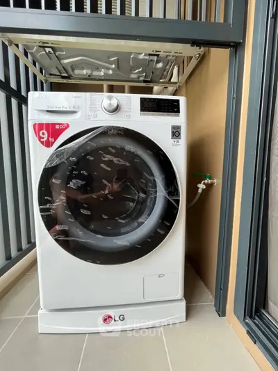 Modern LG washing machine on a balcony with sleek design and efficient functionality.