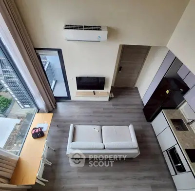 Modern apartment interior with open kitchen and city view, featuring sleek design and natural light.