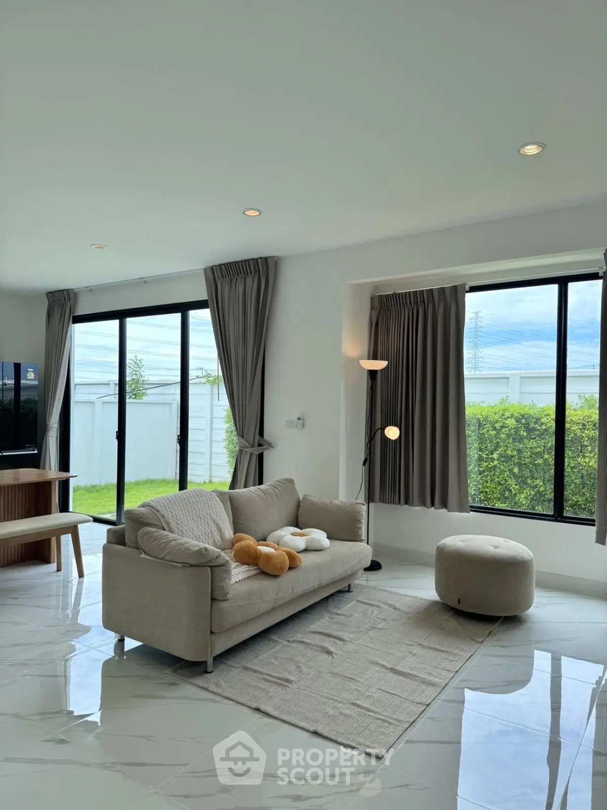 Spacious modern living room with large windows and stylish decor
