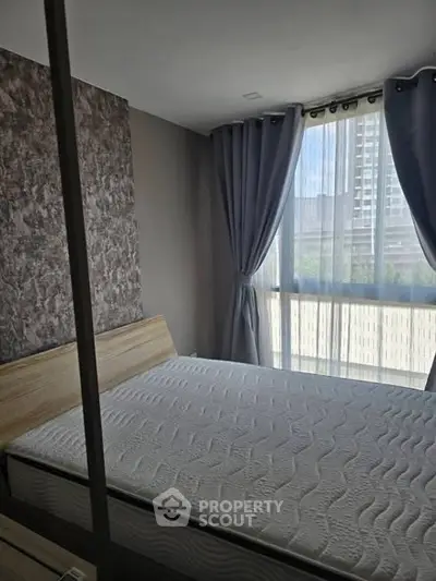 Modern bedroom with large window and stylish curtains in a high-rise apartment.