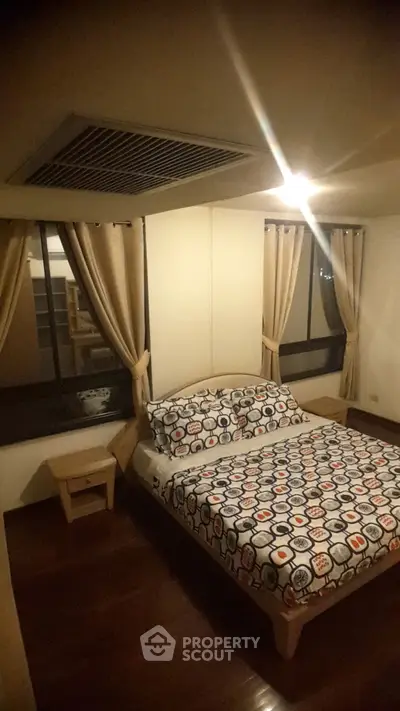 Cozy bedroom with stylish bedding and warm lighting in modern apartment