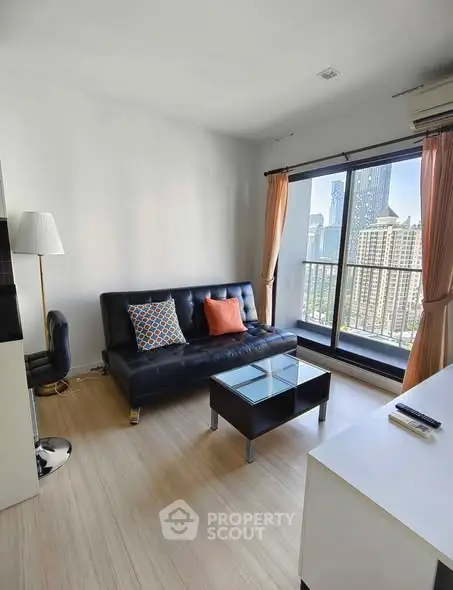 Modern living room with city view, stylish sofa, and floor-to-ceiling windows.