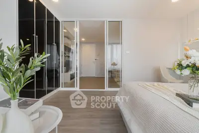 Modern bedroom with elegant decor and glass wardrobe doors