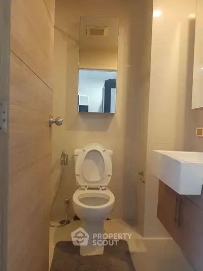 Compact modern bathroom with sleek fixtures and neutral tones