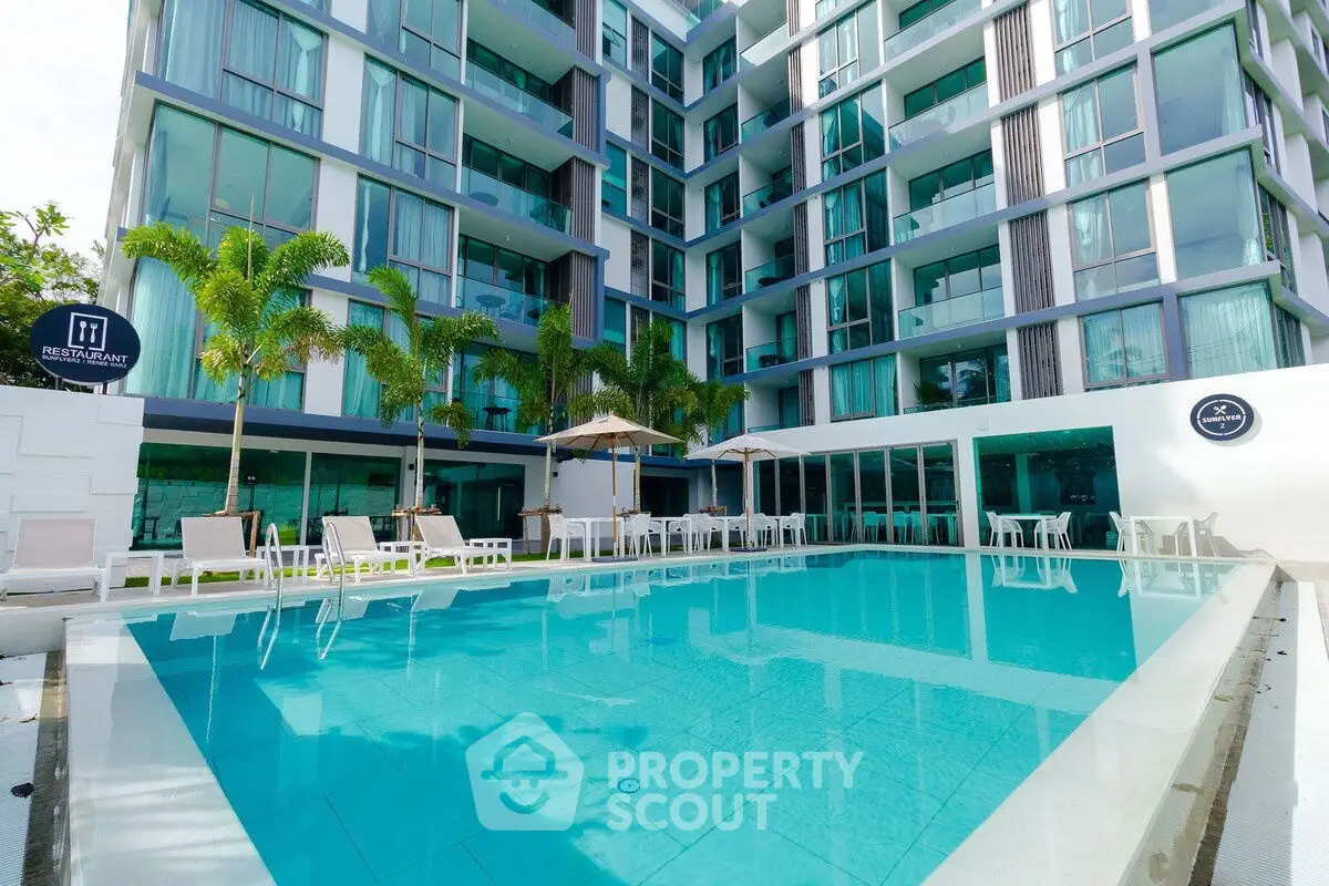 Luxurious modern apartment complex with stunning pool and palm trees