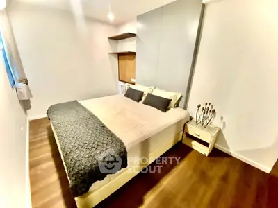 Cozy modern bedroom with stylish decor and ample natural light