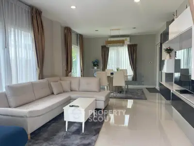 Spacious modern living room with elegant dining area and natural light