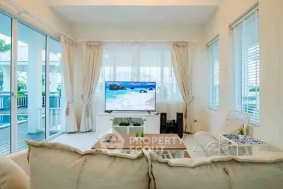 Spacious living room with modern decor and large windows offering natural light.