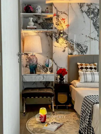 Luxurious bedroom with marble accents and elegant decor, featuring a cozy reading nook and ambient lighting.