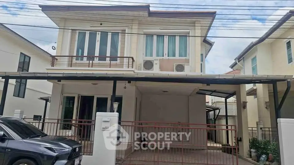 Modern two-story house with spacious carport and sleek exterior design in a suburban neighborhood.