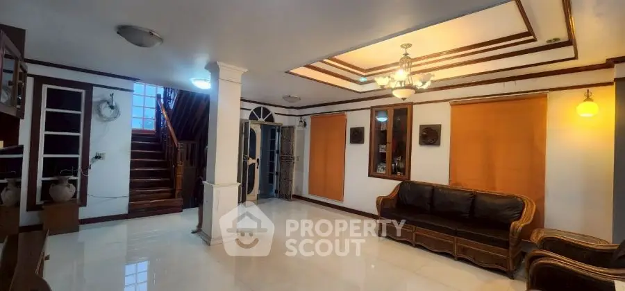 Spacious living room with elegant staircase and cozy seating area