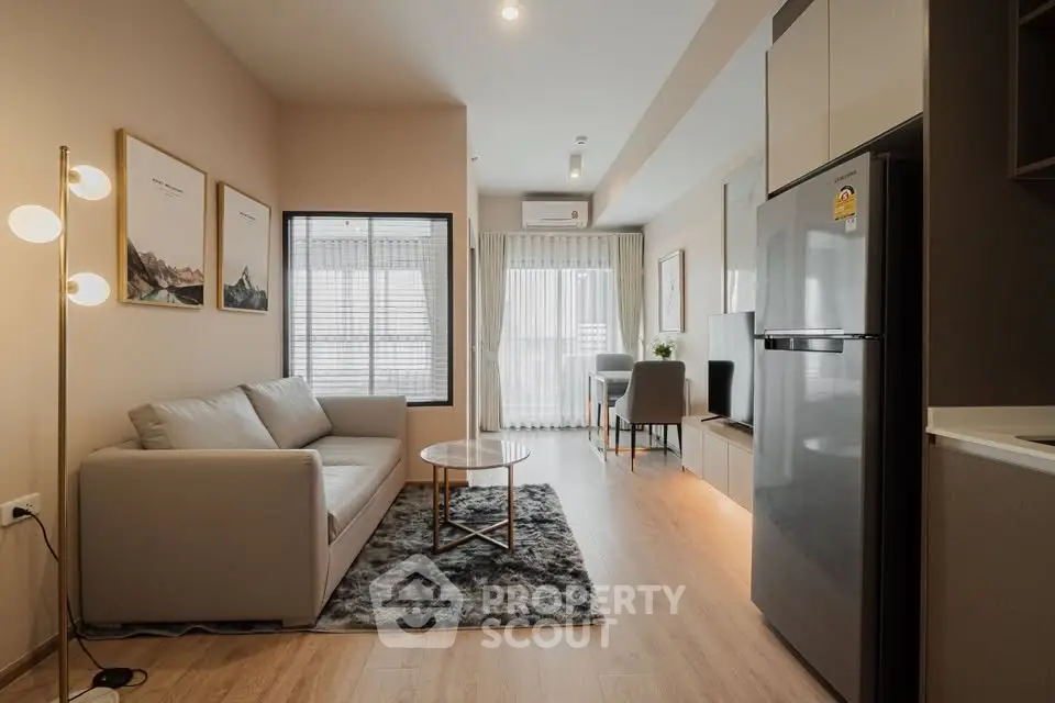 Modern living room with cozy sofa and stylish decor in open-plan apartment.