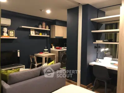 Modern studio apartment with stylish decor and compact kitchen