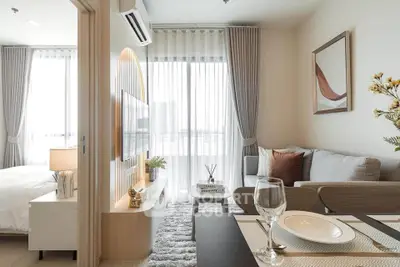 Modern living room with stylish decor and natural light, featuring a cozy sofa and elegant dining area.