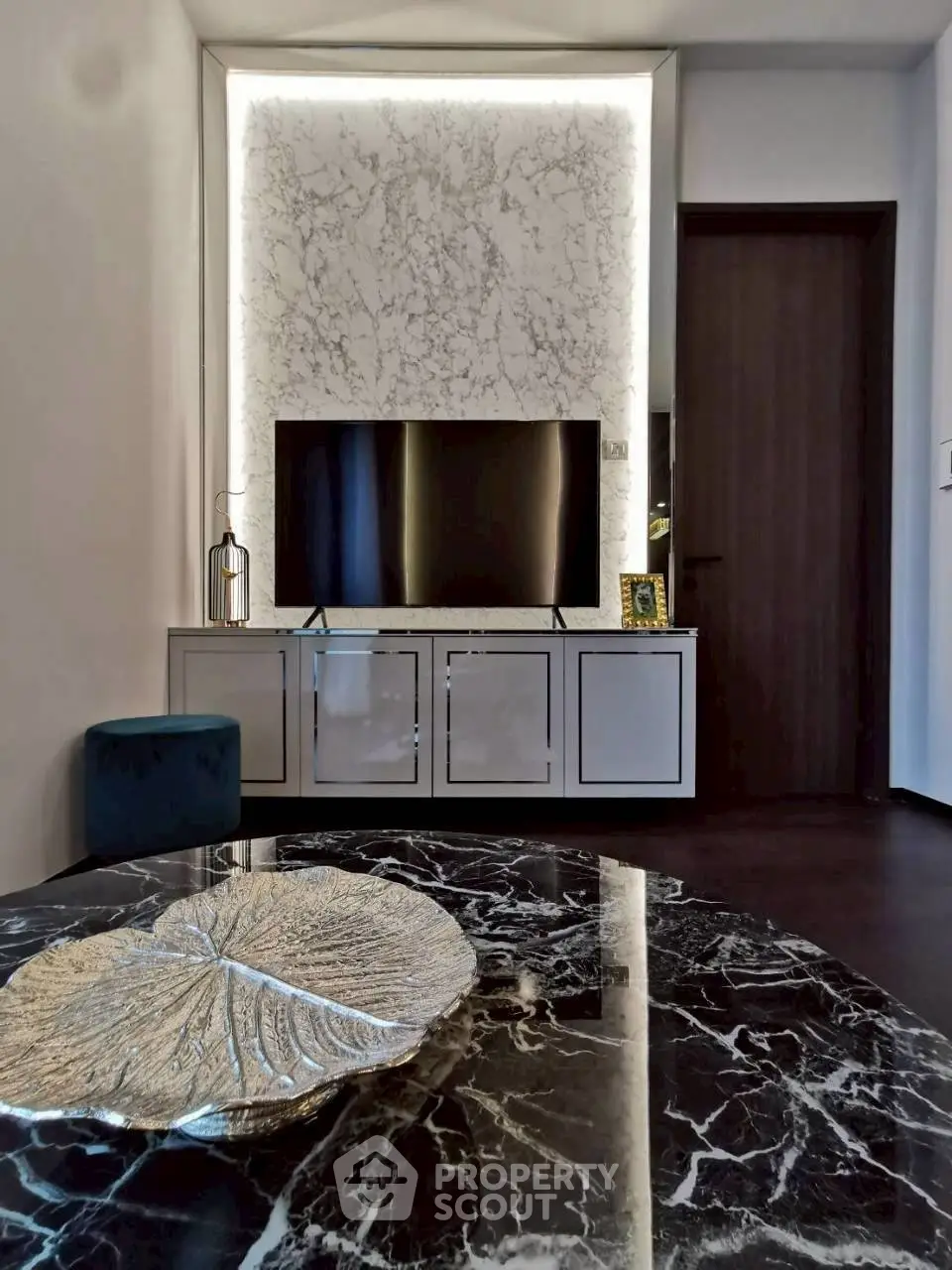 Luxurious living room with marble accents and modern TV setup