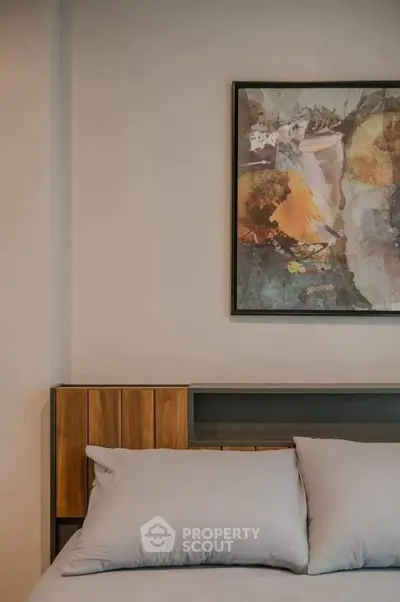 Modern bedroom with stylish artwork and cozy bedding