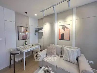 Modern living room with cozy sofa and dining area, featuring stylish decor and soft lighting.