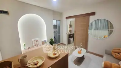 Modern living room with cozy decor and sliding door leading to a small kitchen area.