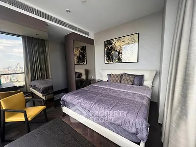 Luxurious bedroom with city view, modern decor, and elegant furnishings in high-rise apartment.