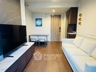 Modern living room with sleek furniture and elegant decor in a stylish apartment.