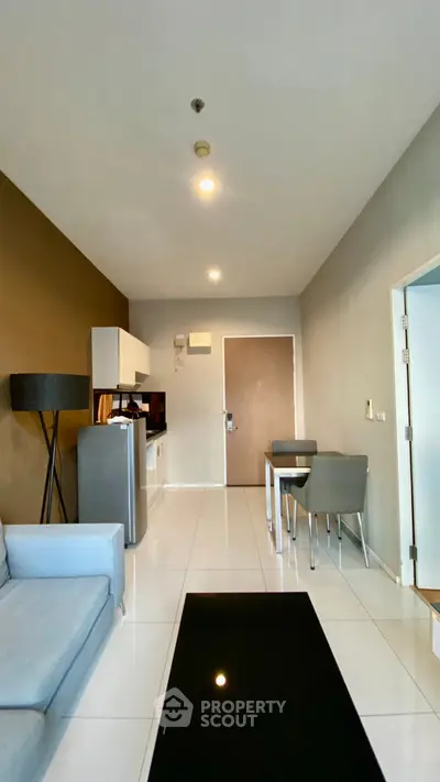 Modern open-layout living room with sleek furniture and integrated kitchen area.