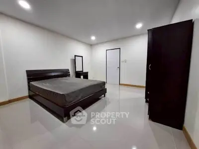 Spacious bedroom with modern furniture and sleek design