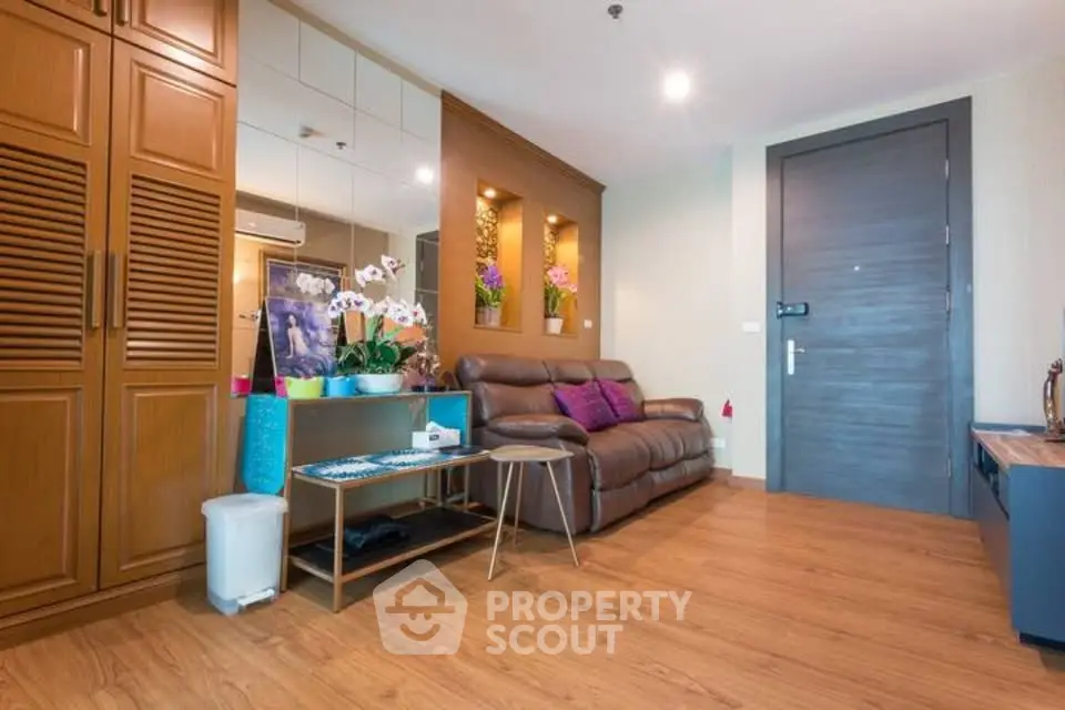 Stylish living room with wooden flooring and cozy leather sofa in modern apartment.