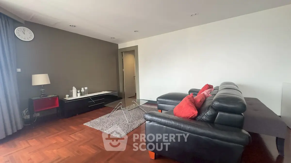 Spacious living room with modern leather sofa and stylish decor, perfect for relaxation and entertainment.