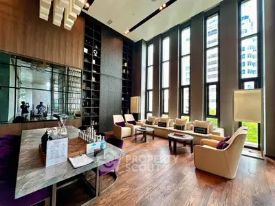Luxurious high-ceiling living room with modern decor and large windows offering stunning city views.