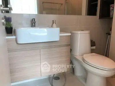 Modern bathroom with sleek fixtures and stylish vanity in a contemporary home.