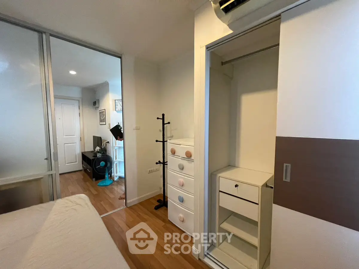 Modern bedroom with sliding closet doors and wooden flooring