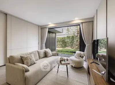 Modern living room with large sofa, TV, and open view to garden