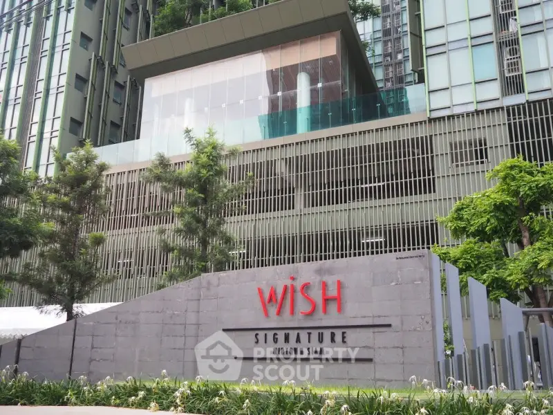 Modern high-rise building with lush greenery at Wish Signature Midtown Siam.