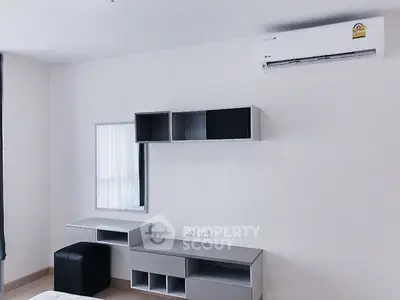 Sleek minimalist living room with modern air conditioning unit and stylish modular shelving, perfect for urban living.