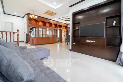 Spacious living room with modern decor and large TV unit