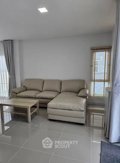 Spacious modern living room with sleek leather sofa and elegant decor