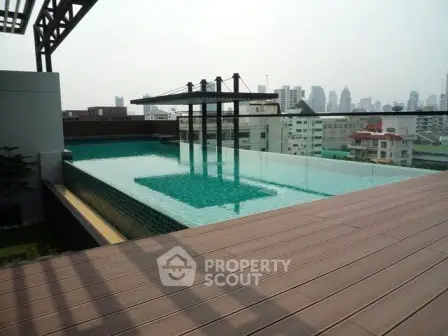 Luxurious rooftop pool with stunning city skyline views in modern urban setting.