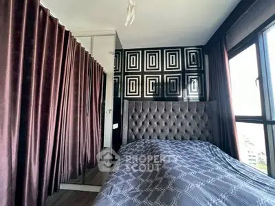 Stylish bedroom with modern decor and large window for natural light.