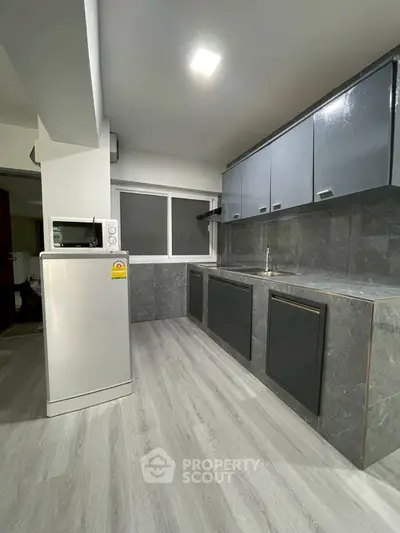 Modern kitchen with sleek cabinets and marble countertops
