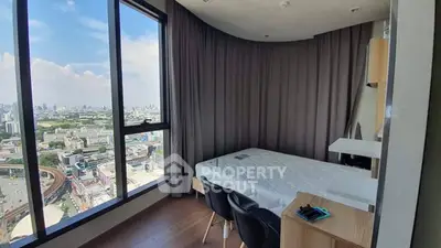 Stunning bedroom with panoramic city view and modern furnishings in high-rise apartment.