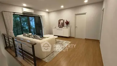 Spacious living room with modern decor and balcony view